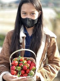Close-up of woman with strawberries
