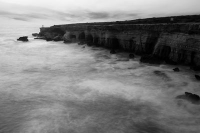 Scenic view of sea against cloudy sky