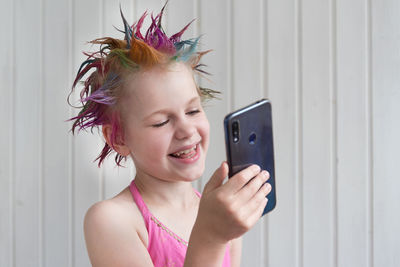 Portrait of smiling woman using mobile phone