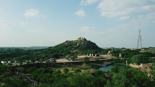 Scenic view of lake and buildings against sky