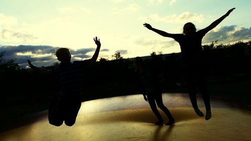 Woman with arms outstretched in background