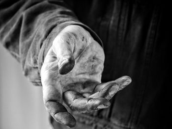 Midsection of manual worker with messy hand