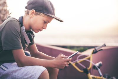 Side view of man using mobile phone