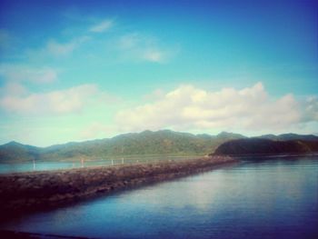 Scenic view of lake against cloudy sky