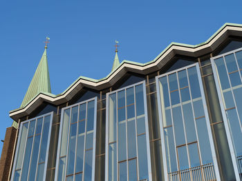 Low angle view of building against clear blue sky