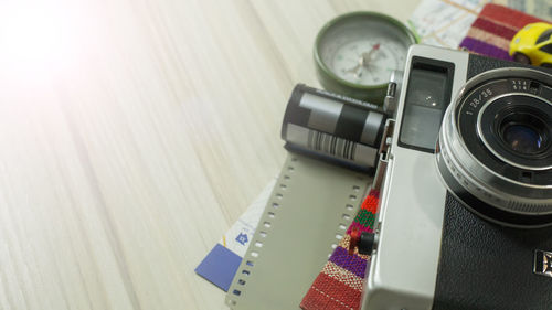 High angle view of technologies and travel equipment on wooden table