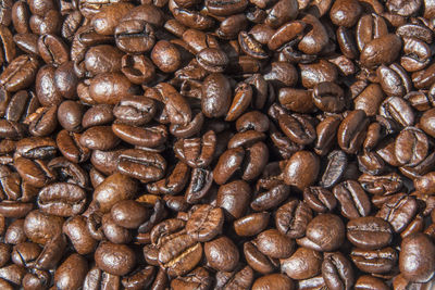 Full frame shot of roasted coffee beans against white background