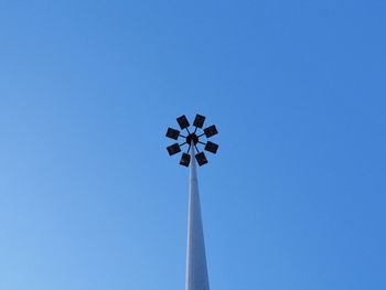 Low angle view of floodlight against clear blue sky