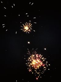 Low angle view of firework display at night
