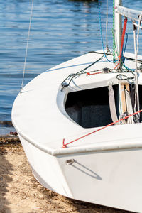 Sailboat sitting on the beach in the summertime.