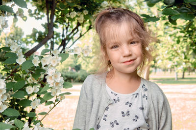 Portrait of smiling girl standing in park