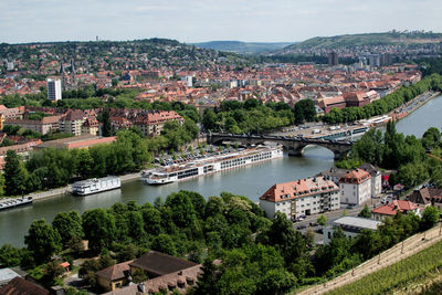 High angle view of townscape by river in city