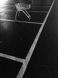 High angle view of shopping cart in parking lot at night