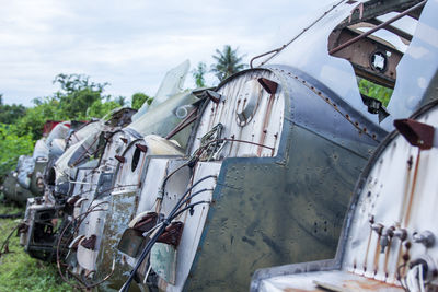 Abandoned airplane on field against sky