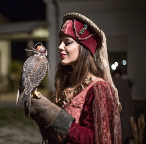 Portrait of woman holding bird