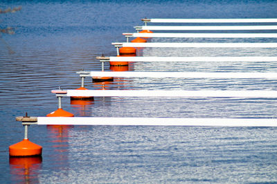 Side view of jetty in rows at rippled water