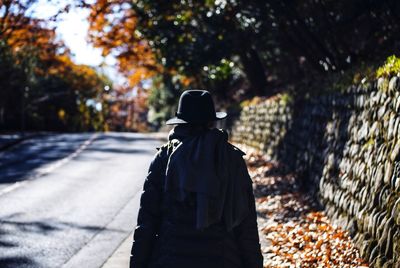 Rear view of man standing on tree