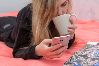 Midsection of woman using mobile phone