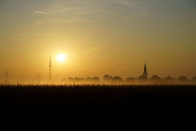 Silhouette temple against sky during sunset