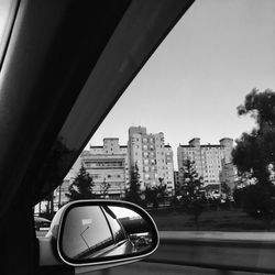 Reflection of road on side-view mirror of car