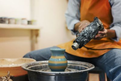Midsection of man working in kitchen