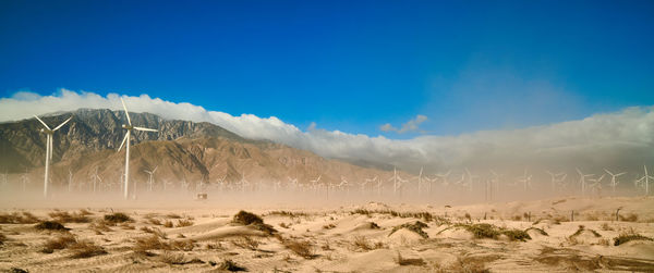 Windmills engulfted in a sandstorm.