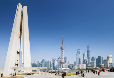 Buildings in city against clear sky