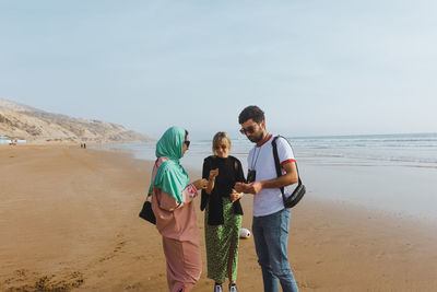 Group of diverse friends on a beach in morocco