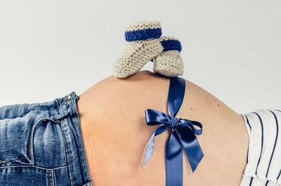 Close-up of woman tied up against white background