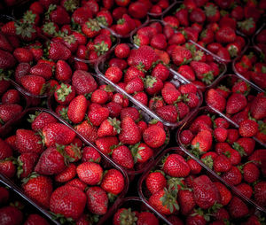 Full frame shot of strawberries in containers at market