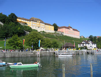 Boats in river with buildings in background