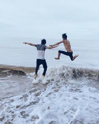 Low angle view of person jumping on beach