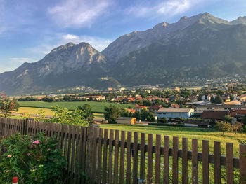 Fence on lawn against mountains