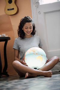 The future is green. young woman with a luminous world globe. love attitude.