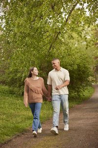 Happy couple walking in park