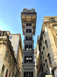 Low angle view of buildings against clear blue sky