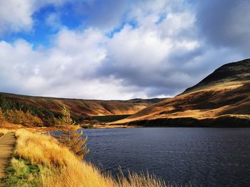 Scenic view of lake and mountains against sky