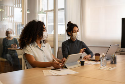 Businesswomen wearing mask working at office