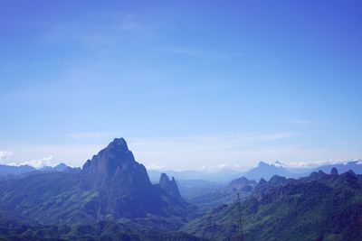 Scenic view of mountains against blue sky