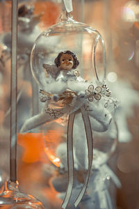 Close-up of figurine on glass