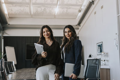 Smiling businesswomen in boardroom