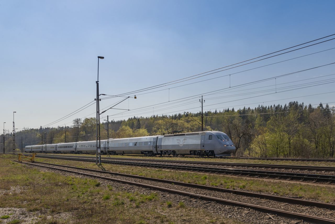 TRAIN ON FIELD AGAINST SKY