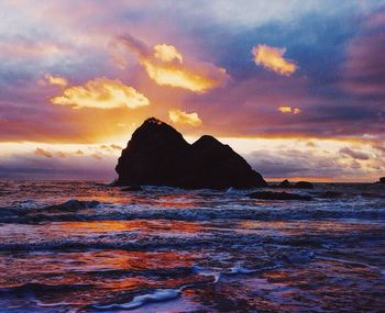 Scenic view of sea against cloudy sky