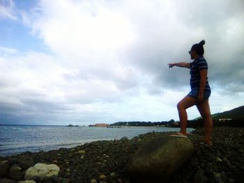 Side view of a man standing at beach