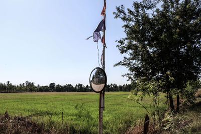 Traditional windmill on field against sky