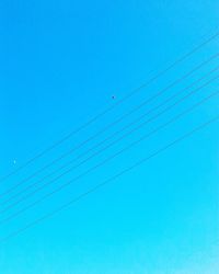 Low angle view of vapor trail against clear blue sky