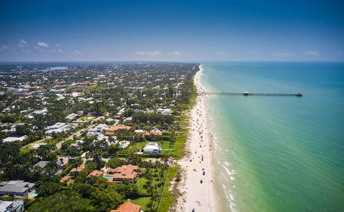 High angle view of sea and buildings against sky