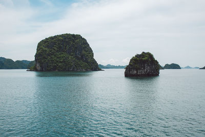 Rocks in sea against sky