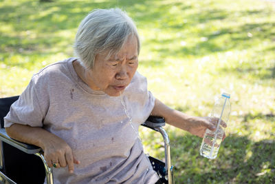 Midsection of woman sitting outdoors