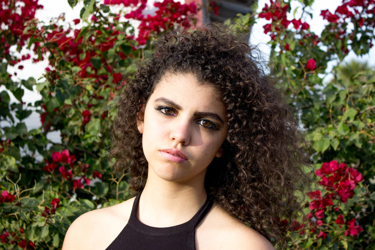 flower, plant, young adult, headshot, freshness, young women, growth, fragility, beauty, nature, focus on foreground, beauty in nature, person, human face, day, outdoors, springtime, green color